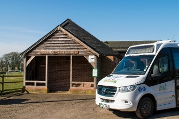 A picture of the Community Connect Northwest Downlands Bus at Brightwalton Village Hall bus stop. 