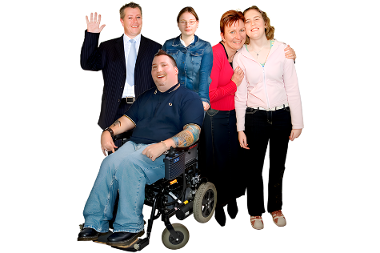 A friendly group of 5 people together smiling. One member of the group is waving.