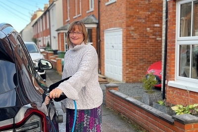 16 Powering up progress woman charging car 16 Powering up progress woman charging car