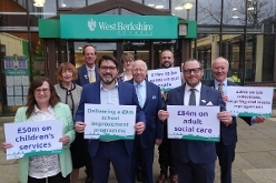 Members of the Executive holding signs